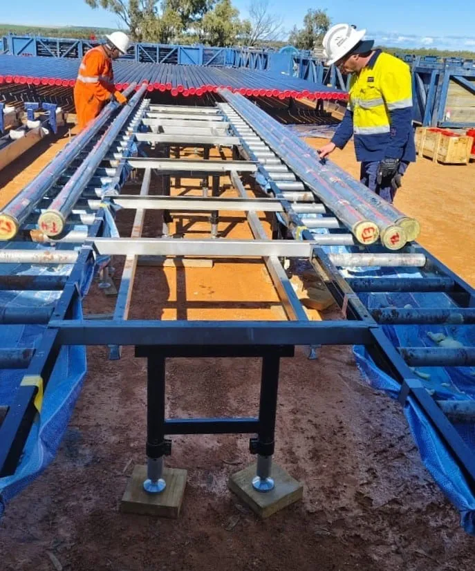 Engineers marking up and measuring core along the processing tables