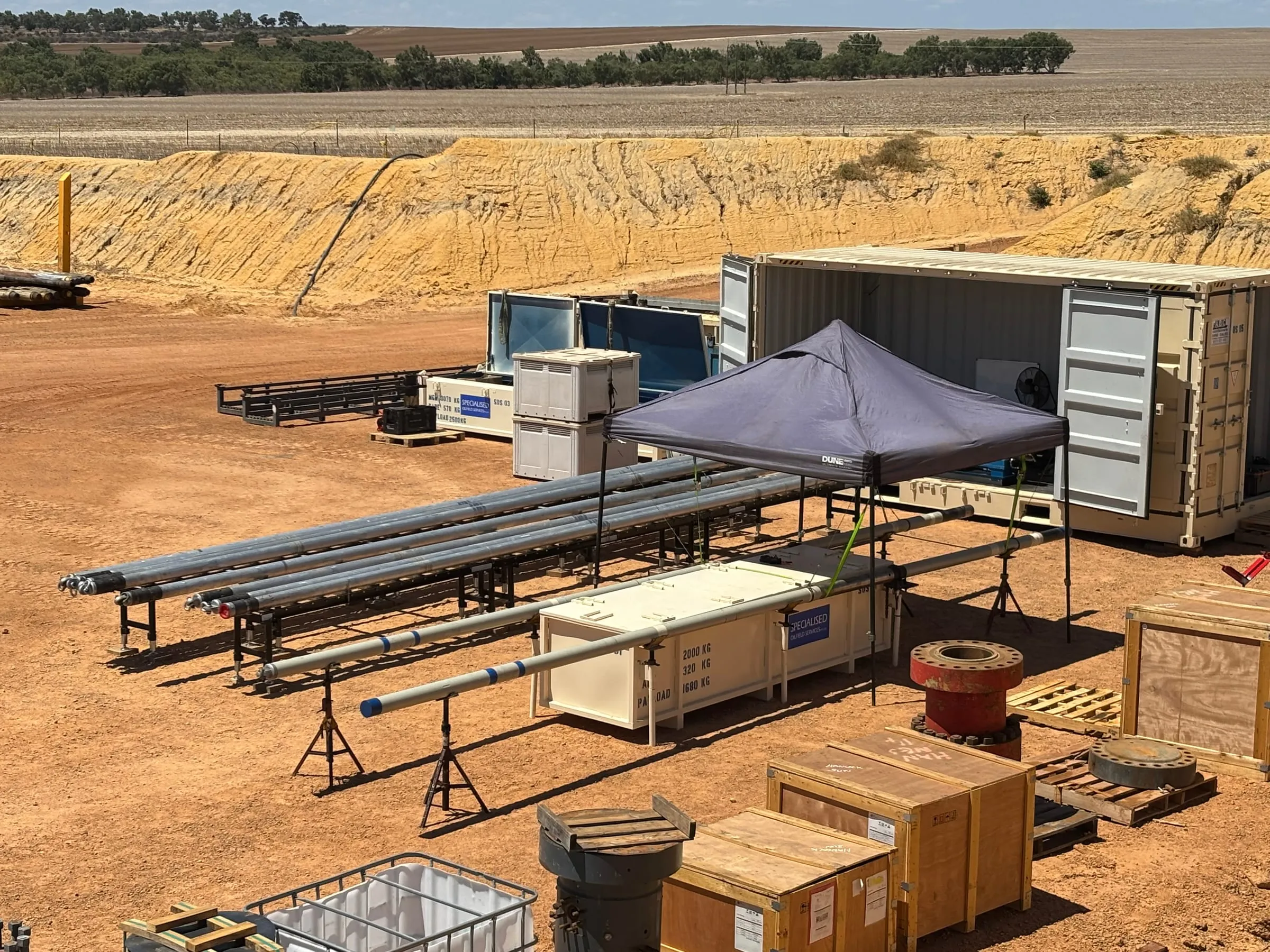 Core processing rack and inner barrels laid out at an onshore wellsite
