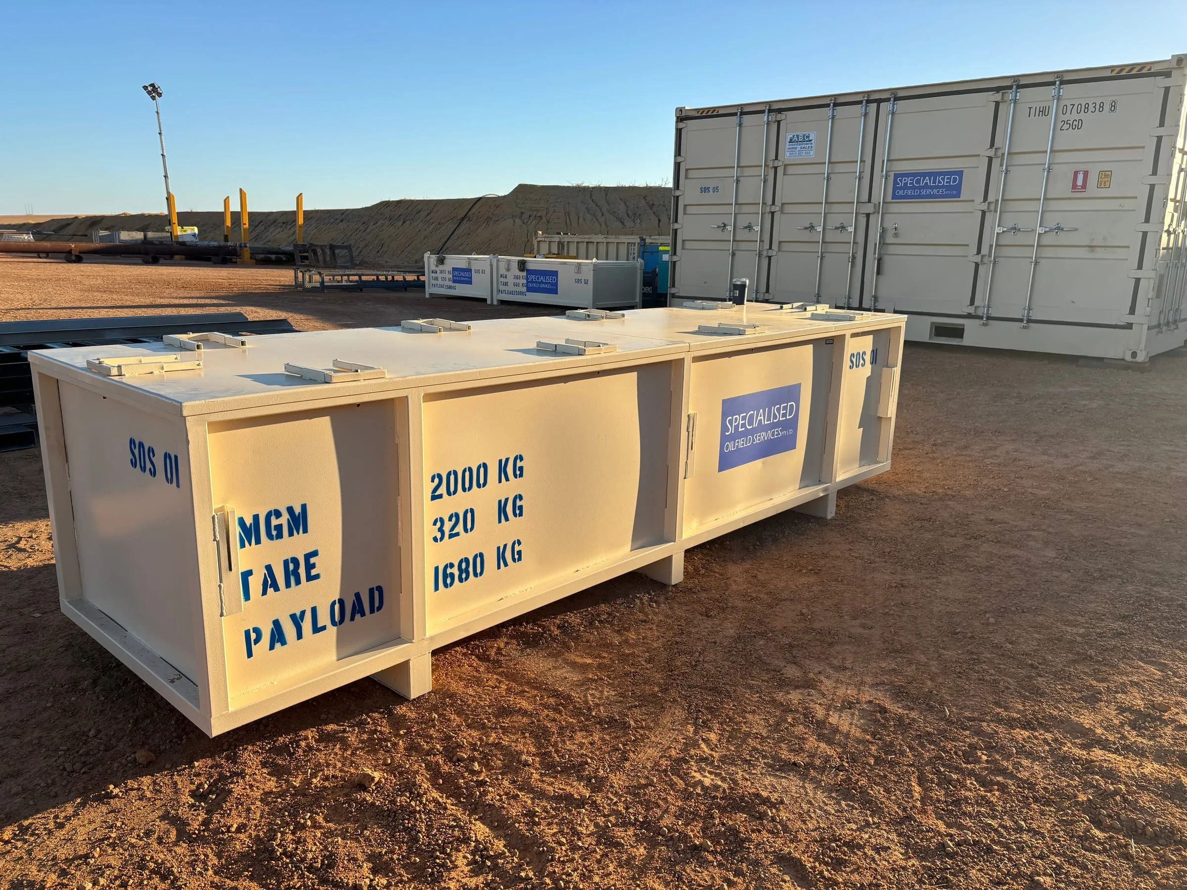 SOS transport baskets and containers laid out on location at an onshore rig site