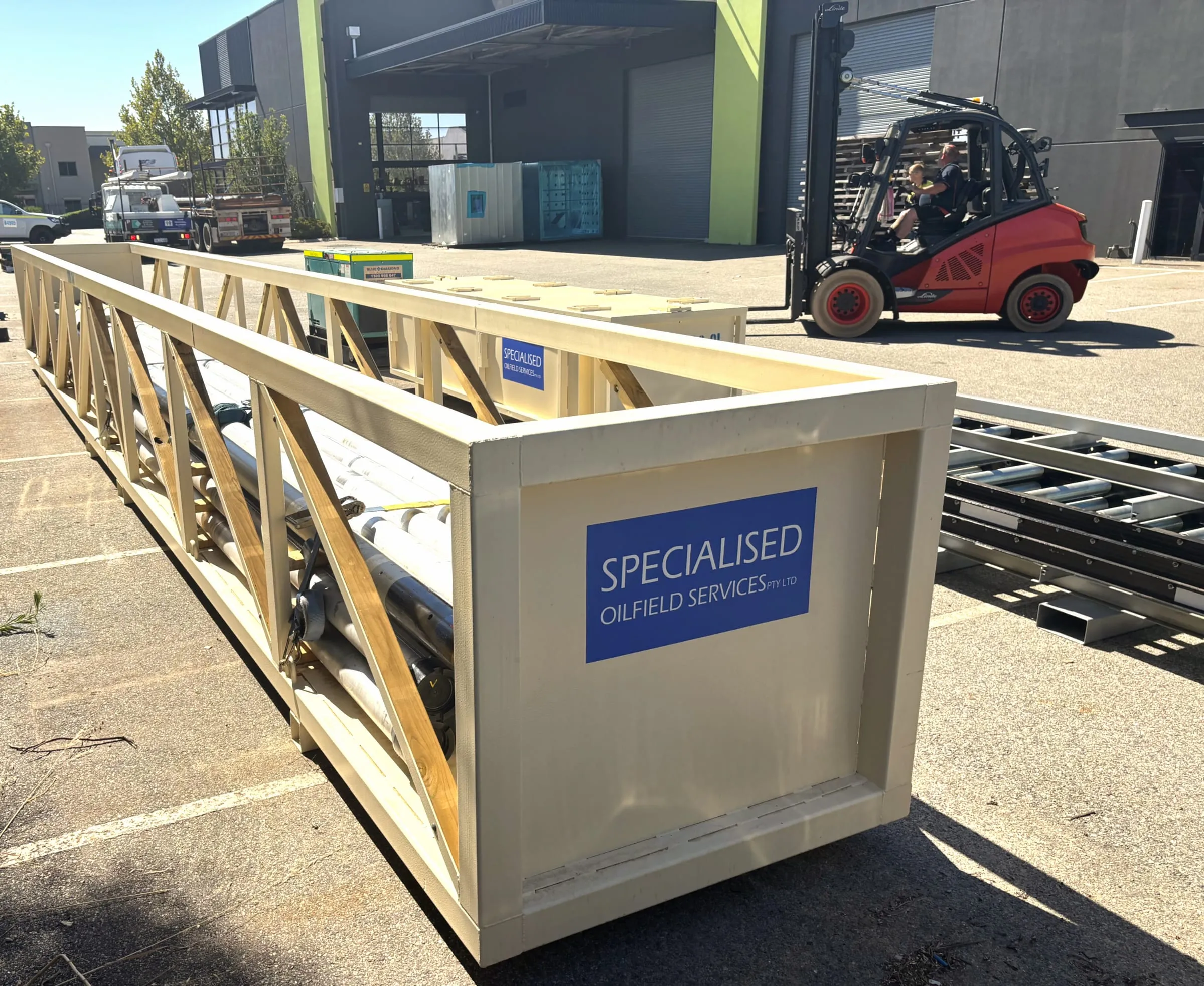 Inner tubes and tools packed into an SOS transport cradle, being loaded at the workshop