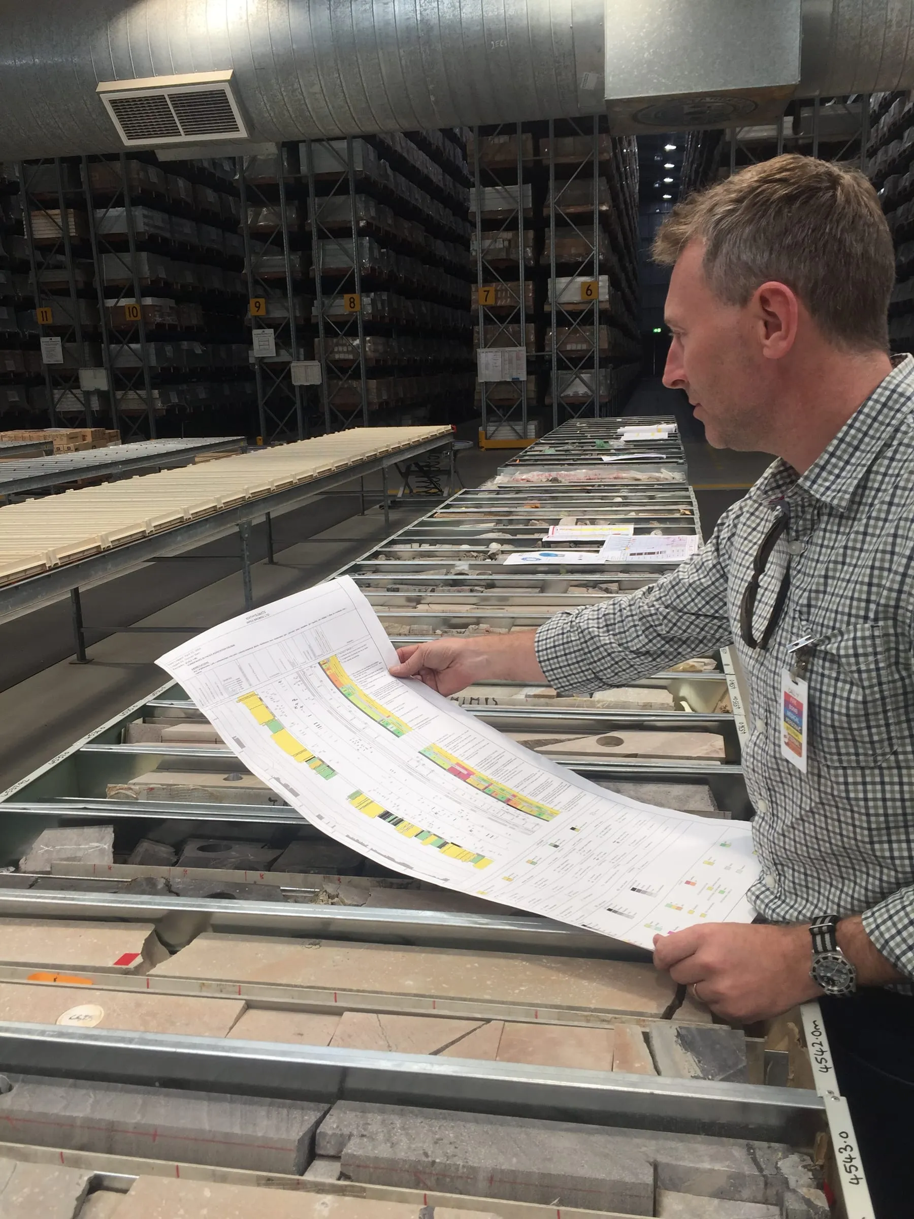 Engineer reviewing a core log in the SOS workshop