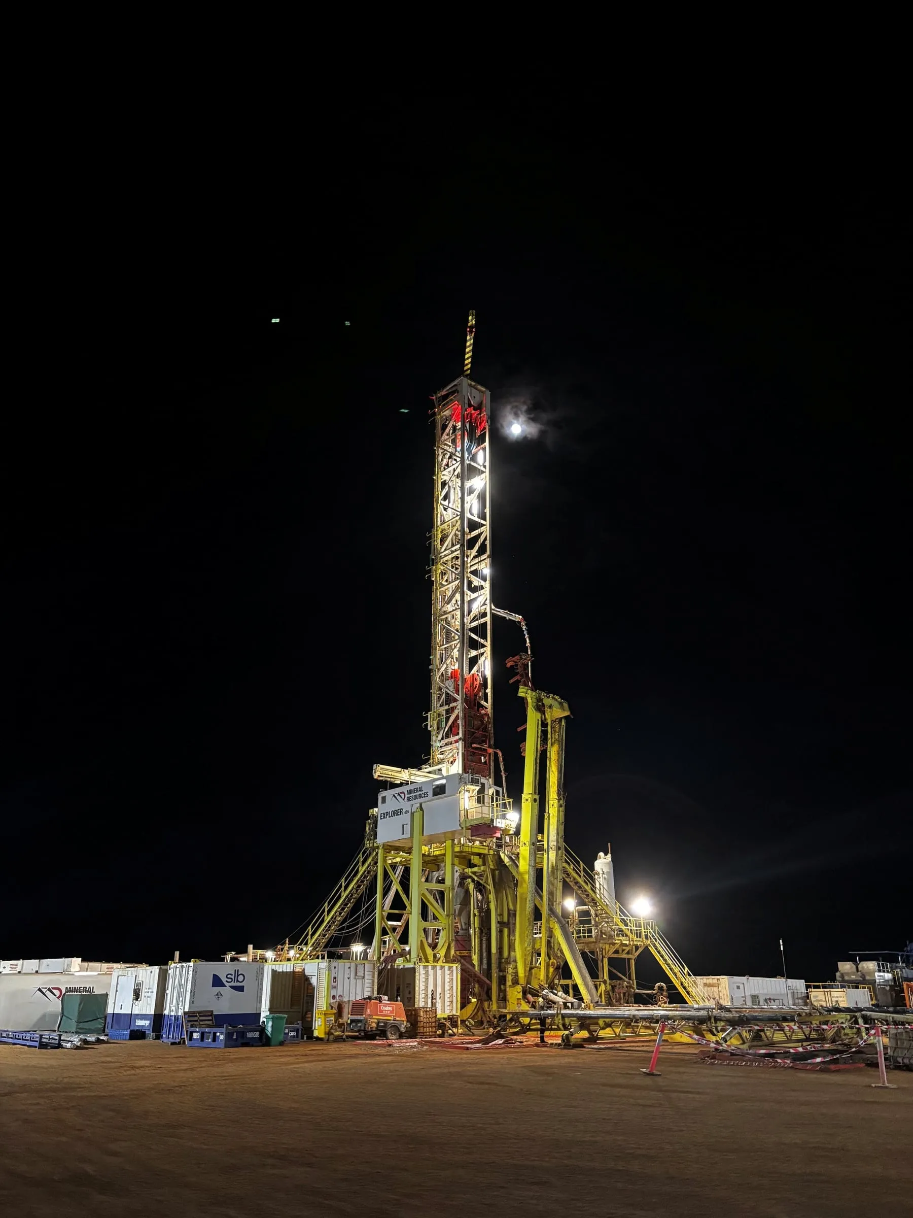 Drilling rig lit up at night on an onshore wellsite