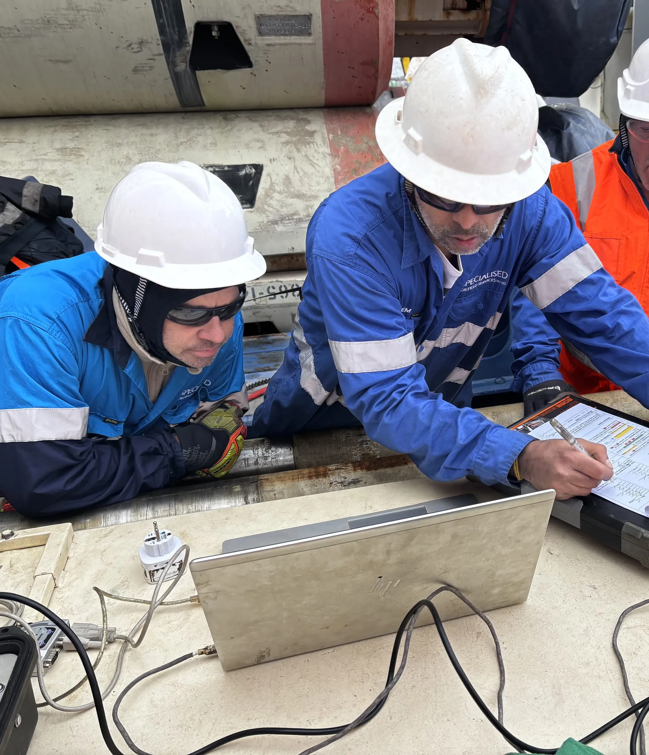 Two engineers carrying out pre-job checks on the SureCore at a wellsite workstation