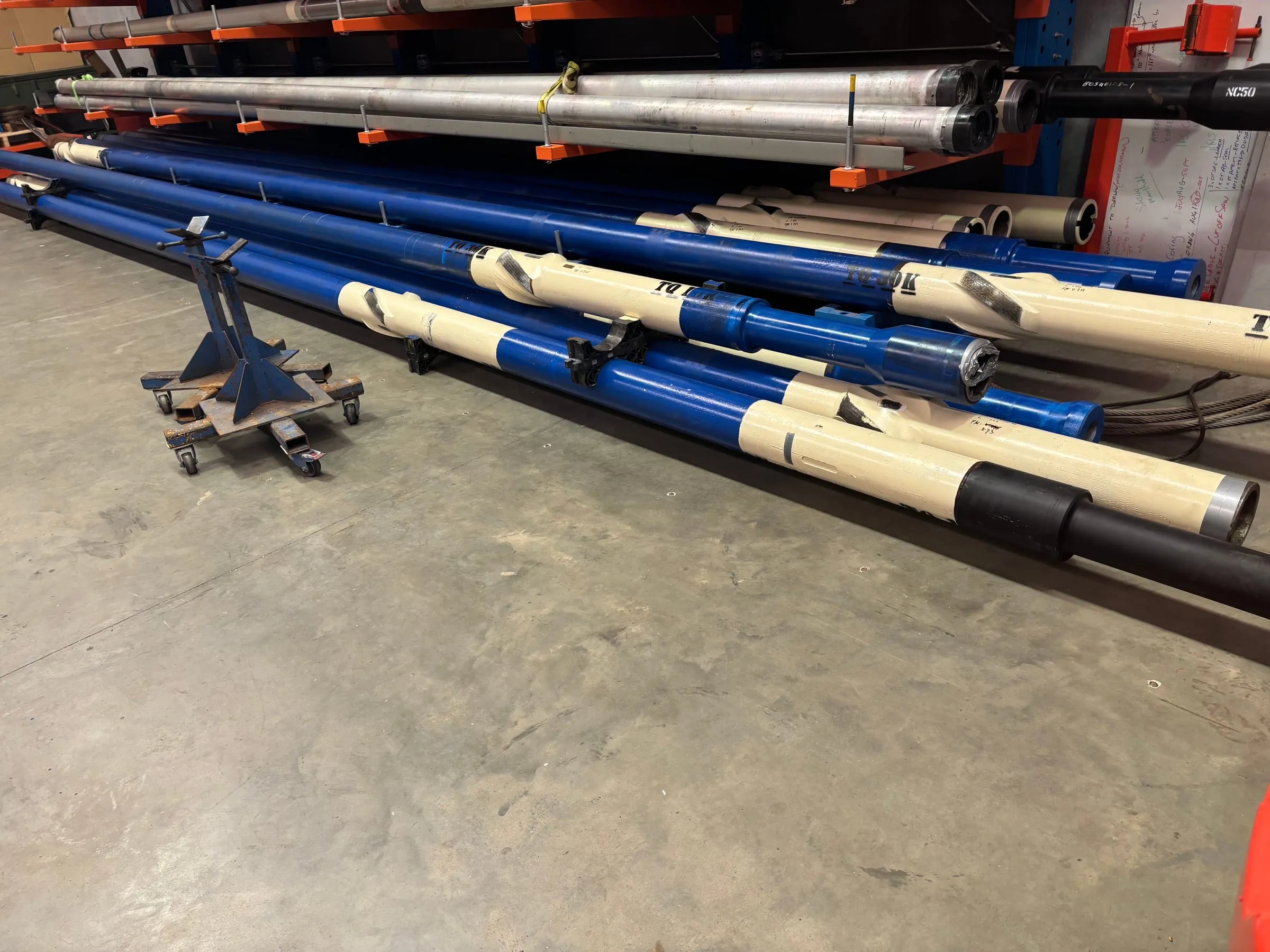 SureCore tools and core barrels racked on the floor of the SOS workshop
